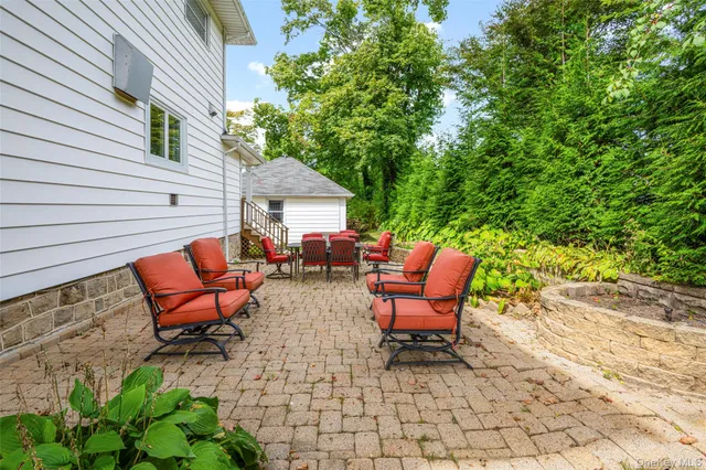 a backyard of a house with couple of chairs