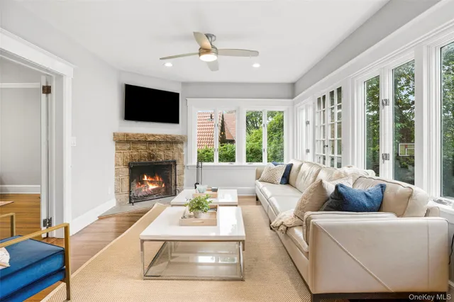 a living room with furniture fireplace and flat screen tv