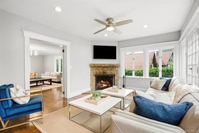 a living room with furniture a fireplace and a flat screen tv