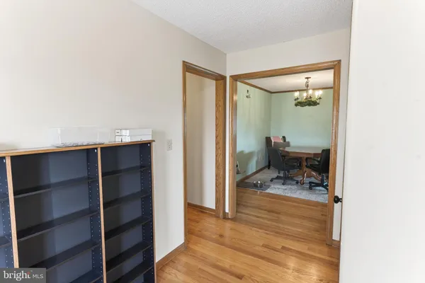 a kitchen with stainless steel appliances granite countertop a refrigerator a stove and a wooden floors