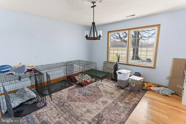 a living room with furniture a flat screen tv and a large window