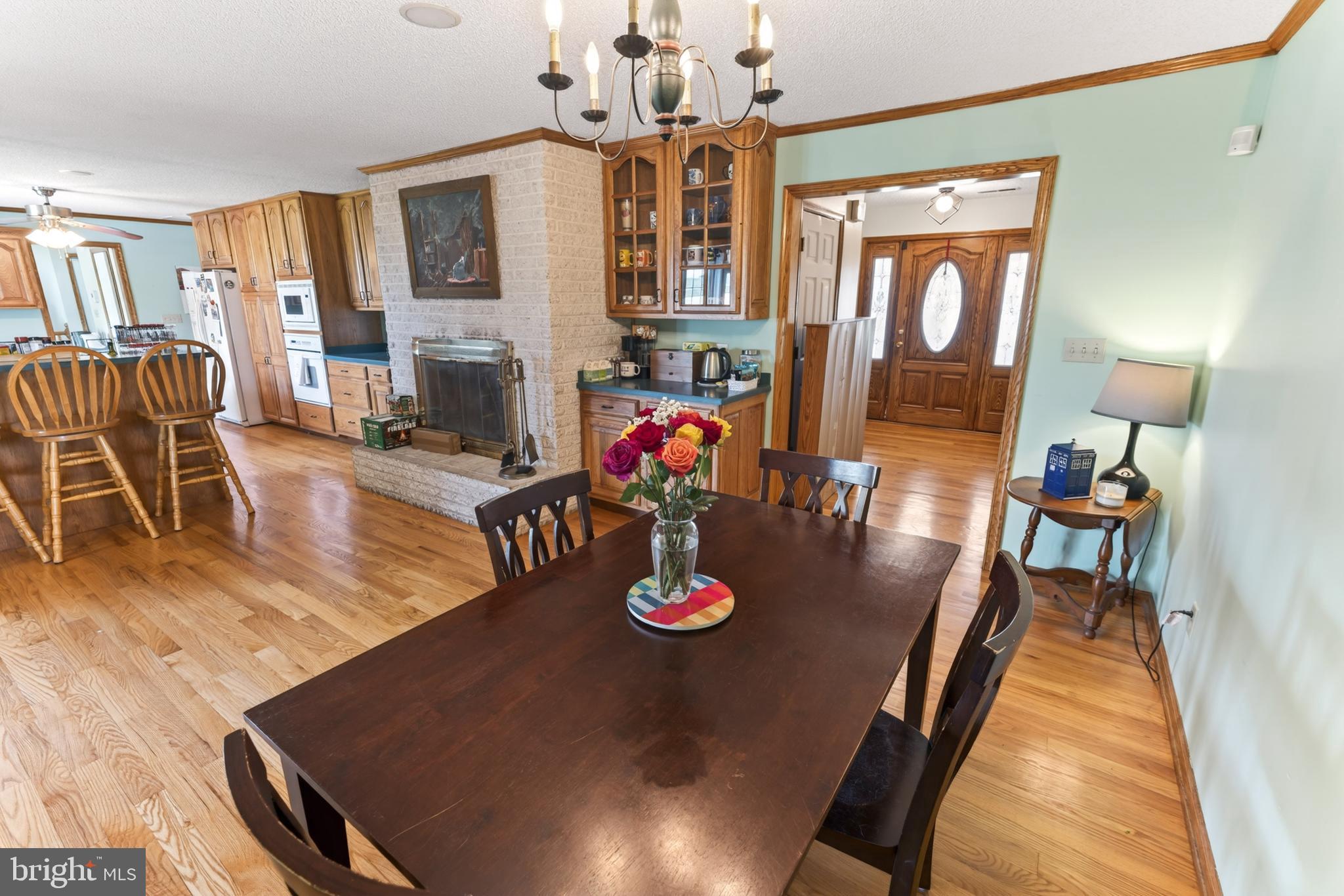 30077 Fire Tower Road Laurel, DE 19956 - Photo 21 of 87 a view of a dining room with furniture a chandelier mirror and wooden floor