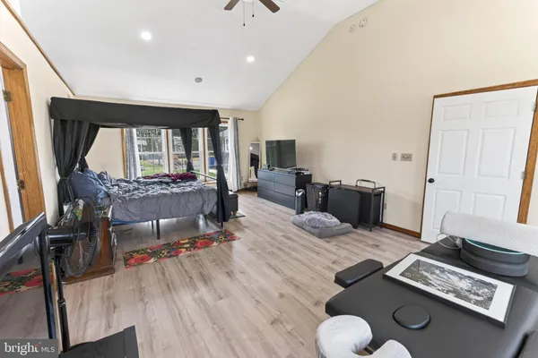 a spacious bedroom with a bed and a chandelier
