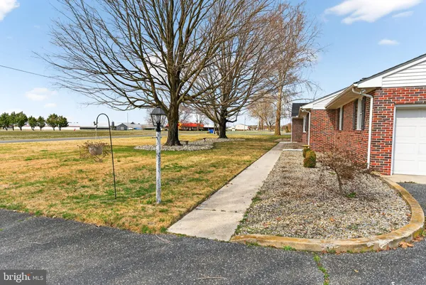 a view of a house with a yard and sitting area