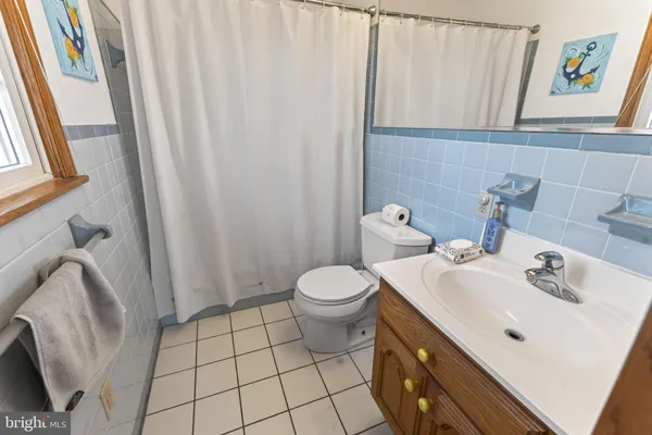 a view of a hallway with wooden floor and closet