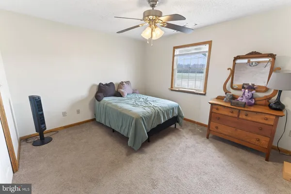 a living room with furniture a dining table and chairs with wooden floor