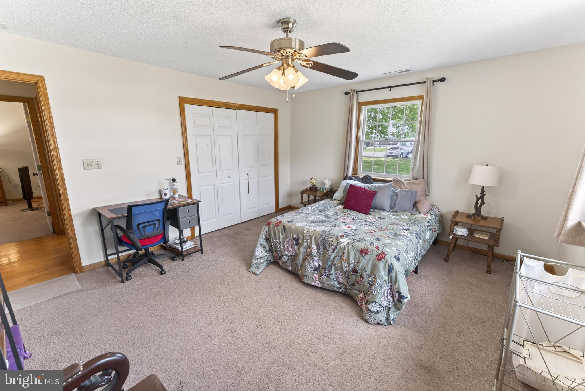 30077 Fire Tower Road Laurel, DE 19956 - Photo 55 of 87 a bedroom with a bed a couch and a chandelier