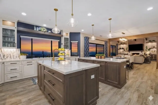 a kitchen with lots of counter space and windows