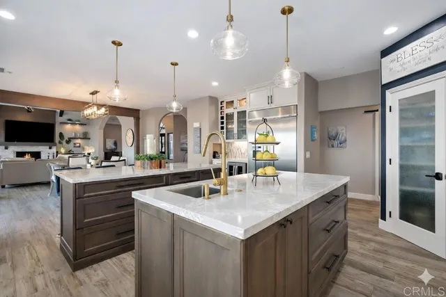 a kitchen with kitchen island a sink stove and refrigerator