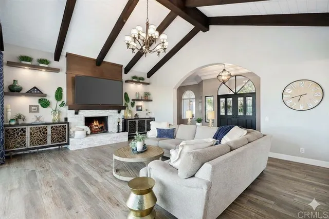 a living room with furniture a fireplace and a flat screen tv
