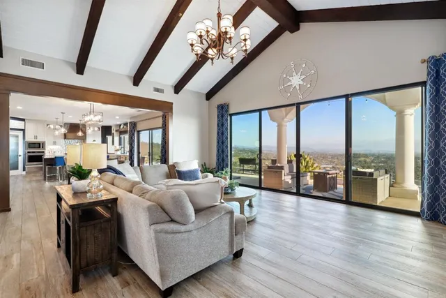 a living room with furniture and large windows