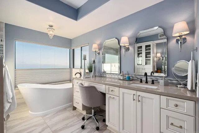 a bathroom with a double vanity sink a mirror and a bathtub
