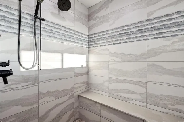 a bathroom with a bathtub and a shower