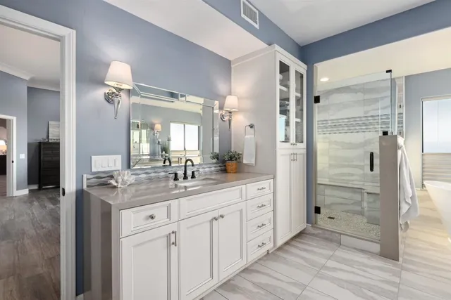 a bathroom with a granite countertop sink mirror and shower