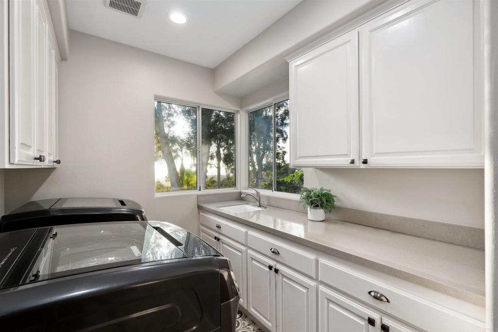 1966 Las Lomas Vista, CA 92084 - Photo 43 of 48 a kitchen with a sink and cabinets