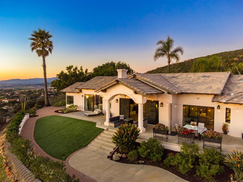 1966 Las Lomas Vista, CA 92084 - Photo 5 of 48 a front view of a house with a garden and patio