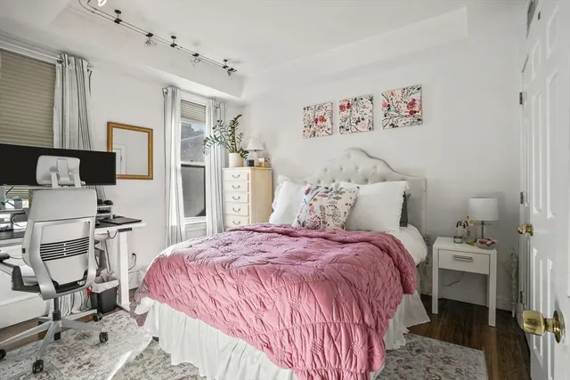 a bed room with a bed and a chair