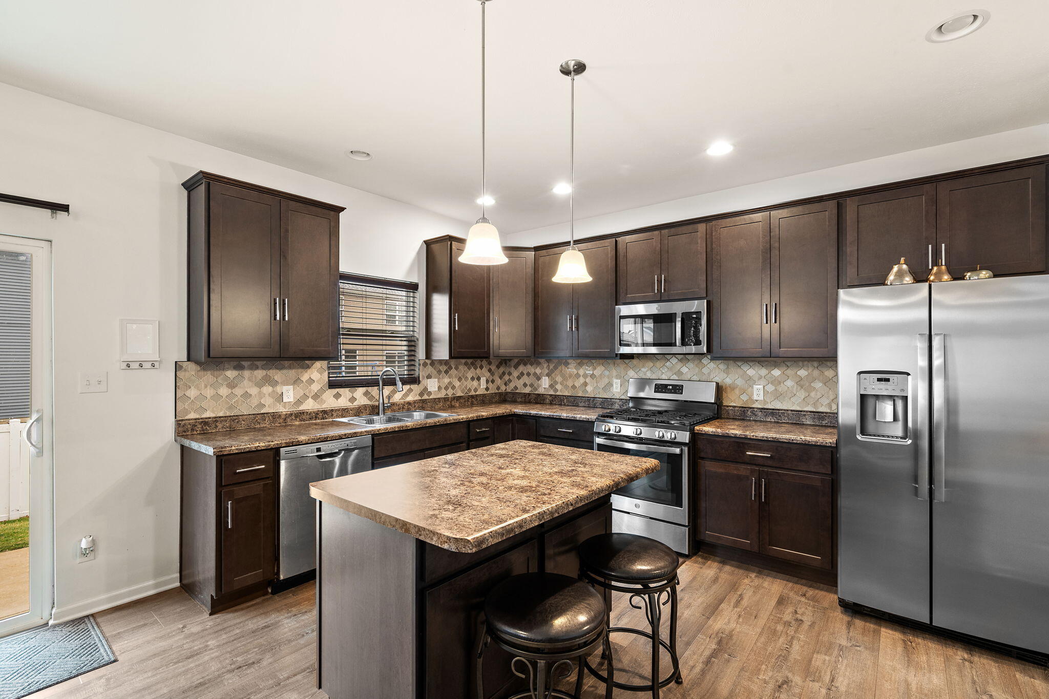 2434 Jupiter Street Portage, IN 46368 - Photo 12 of 30 a kitchen with a stove a refrigerator and a sink