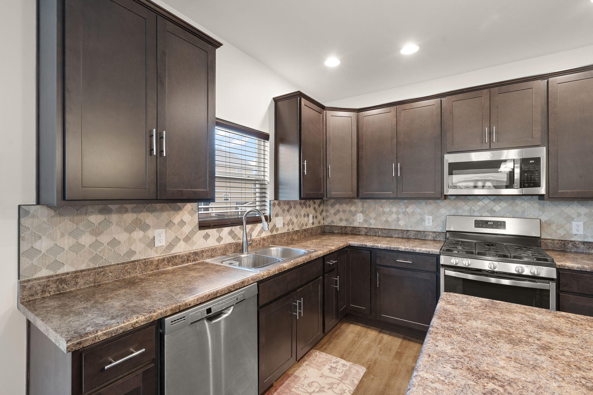 2434 Jupiter Street Portage, IN 46368 - Photo 15 of 30 a kitchen with a sink stove top oven and cabinets