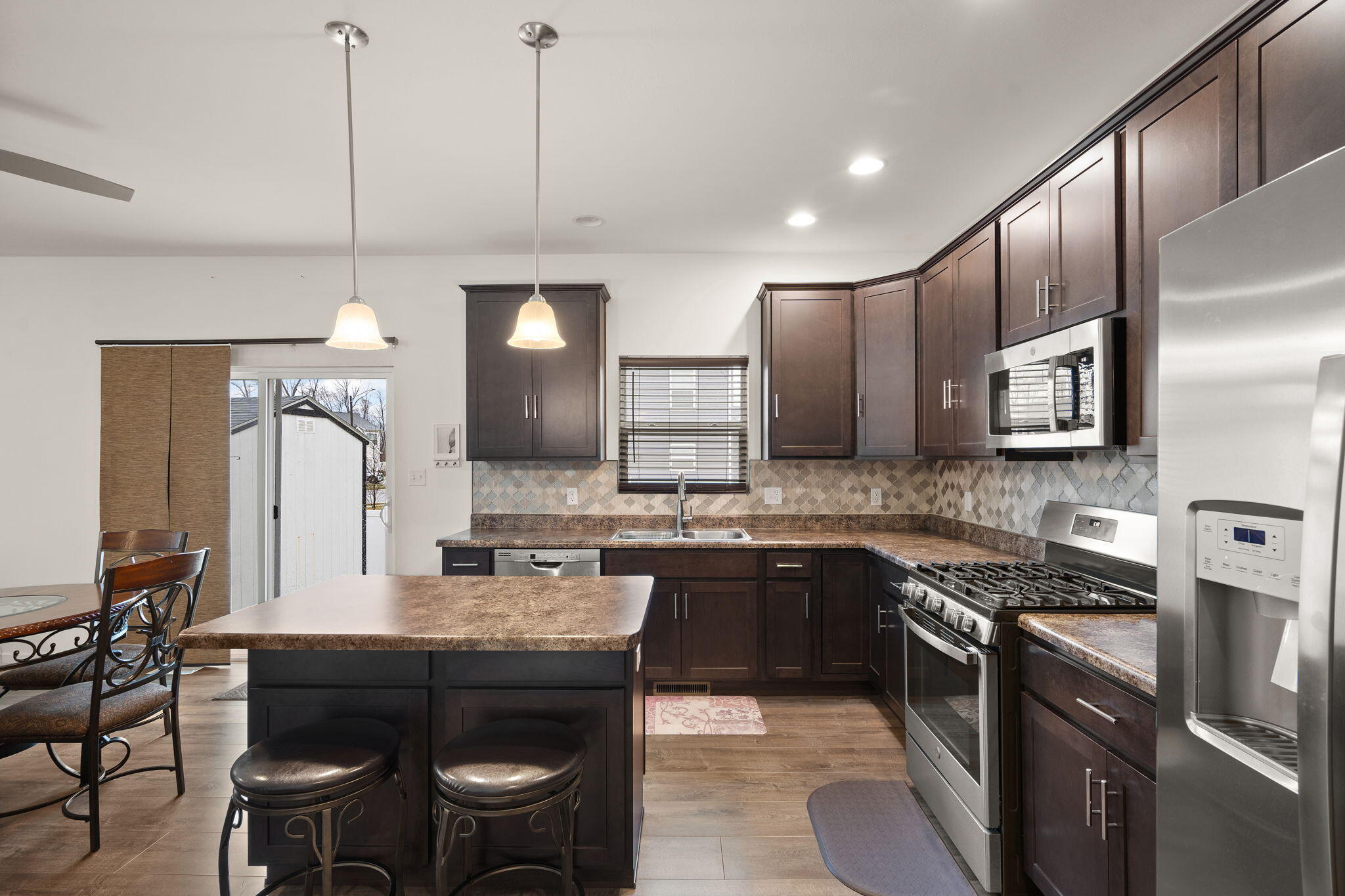 2434 Jupiter Street Portage, IN 46368 - Photo 16 of 30 a large kitchen with a table and chairs in it