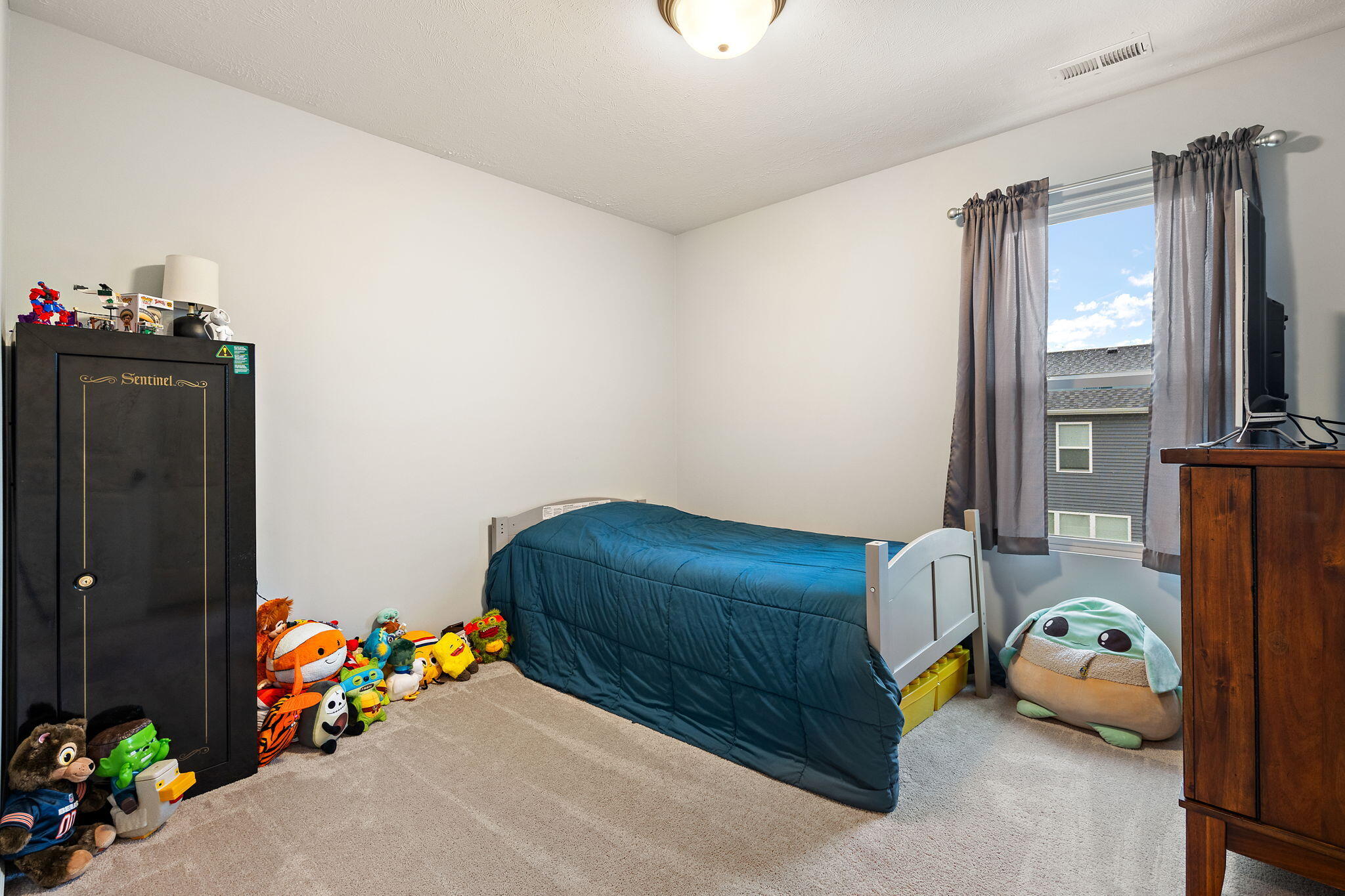 2434 Jupiter Street Portage, IN 46368 - Photo 24 of 30 a bedroom with a bed and a chandelier