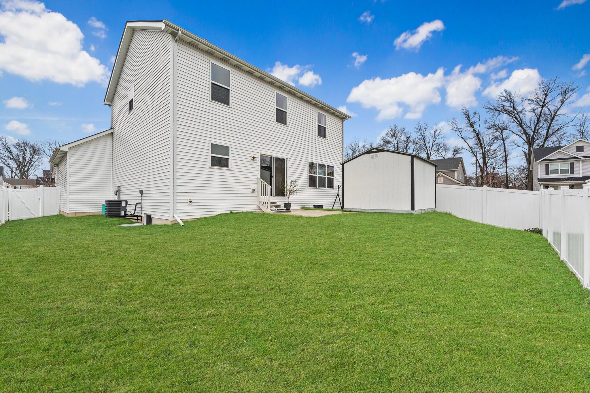 2434 Jupiter Street Portage, IN 46368 - Photo 30 of 30 a view of a white house with a big yard and large trees