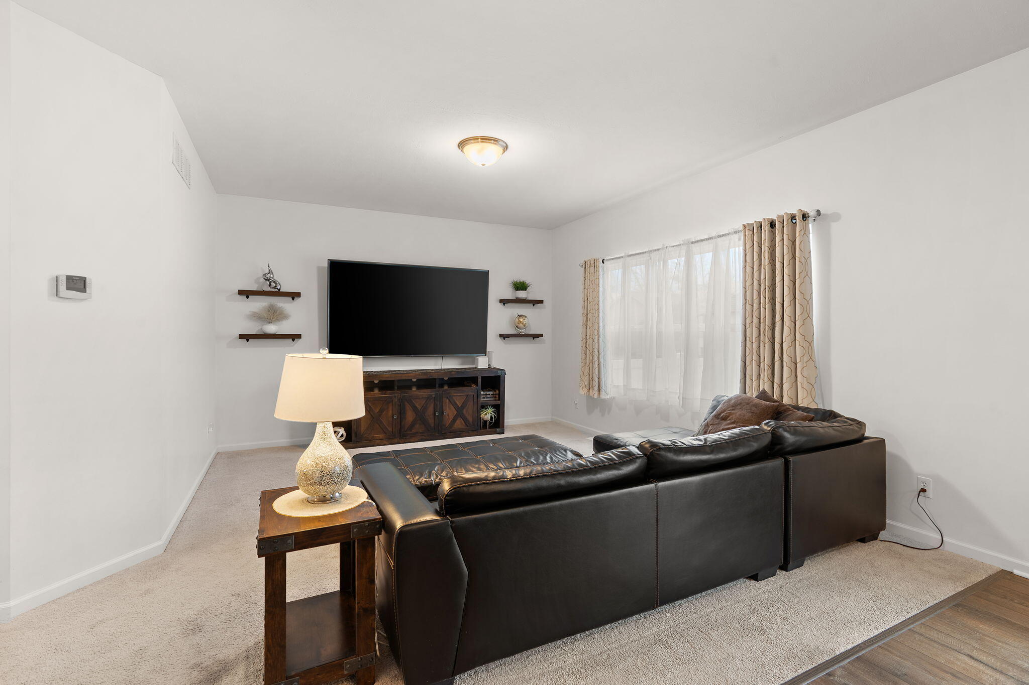2434 Jupiter Street Portage, IN 46368 - Photo 8 of 30 a living room with furniture and a flat screen tv
