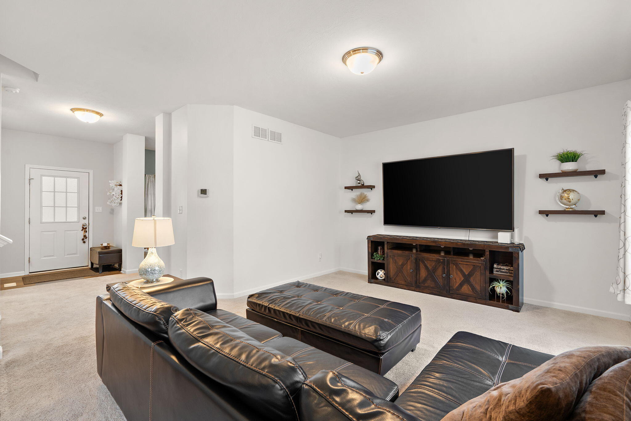 2434 Jupiter Street Portage, IN 46368 - Photo 9 of 30 a living room with furniture and a flat screen tv