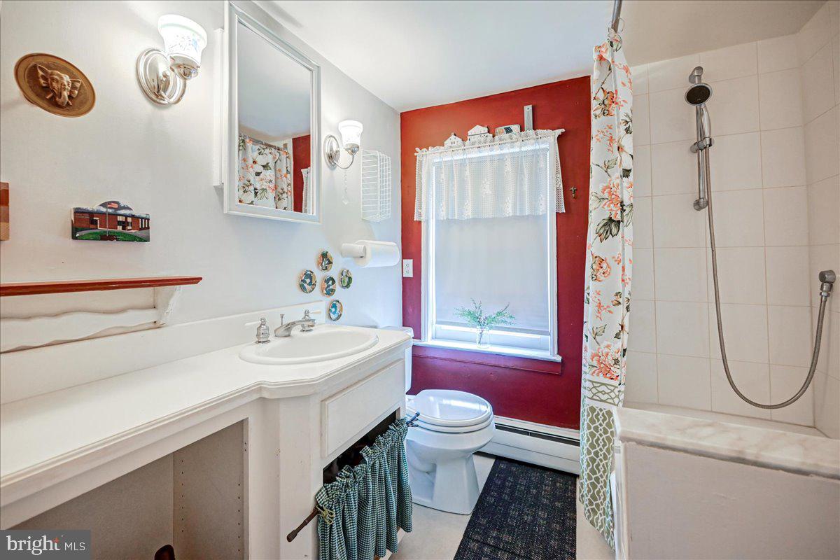 3459 Uniontown Road Westminster, MD 21158 - Photo 18 of 29 a bathroom with a sink a toilet and shower