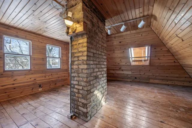 a view of a wooden door and chair in the room