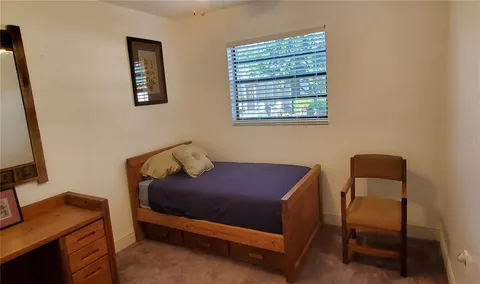 a bedroom with a bed and a desk