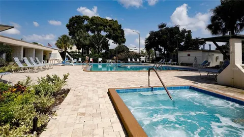 swimming pool view with two chairs in front of it