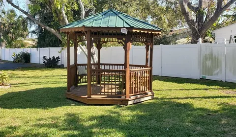 a view of a backyard with wooden fence