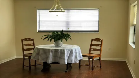 a view of a dining room with furniture and window