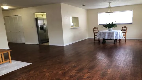 a view of a livingroom with furniture window and wooden floor