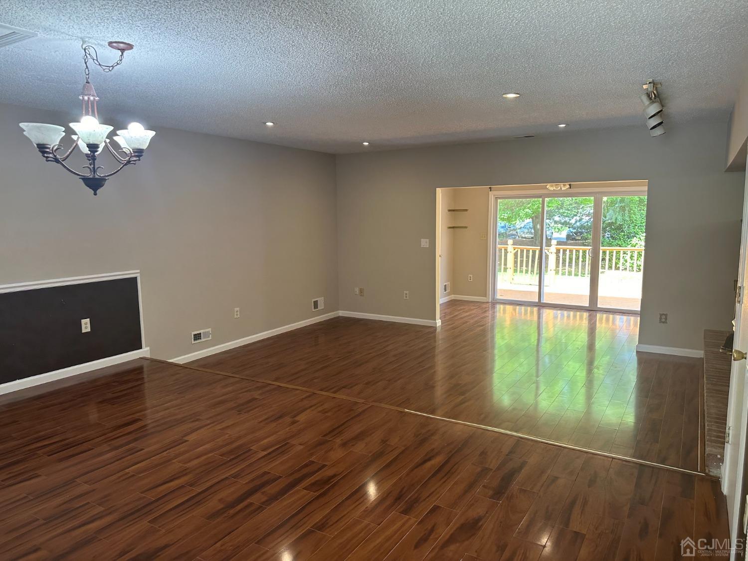 62 Goodwin Drive North Brunswick, NJ 08902 - Photo 1 of 23 a view of an empty room with a window and wooden floor