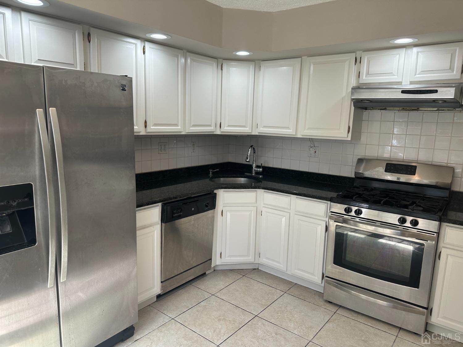 62 Goodwin Drive North Brunswick, NJ 08902 - Photo 11 of 23 a kitchen with cabinets and stainless steel appliances