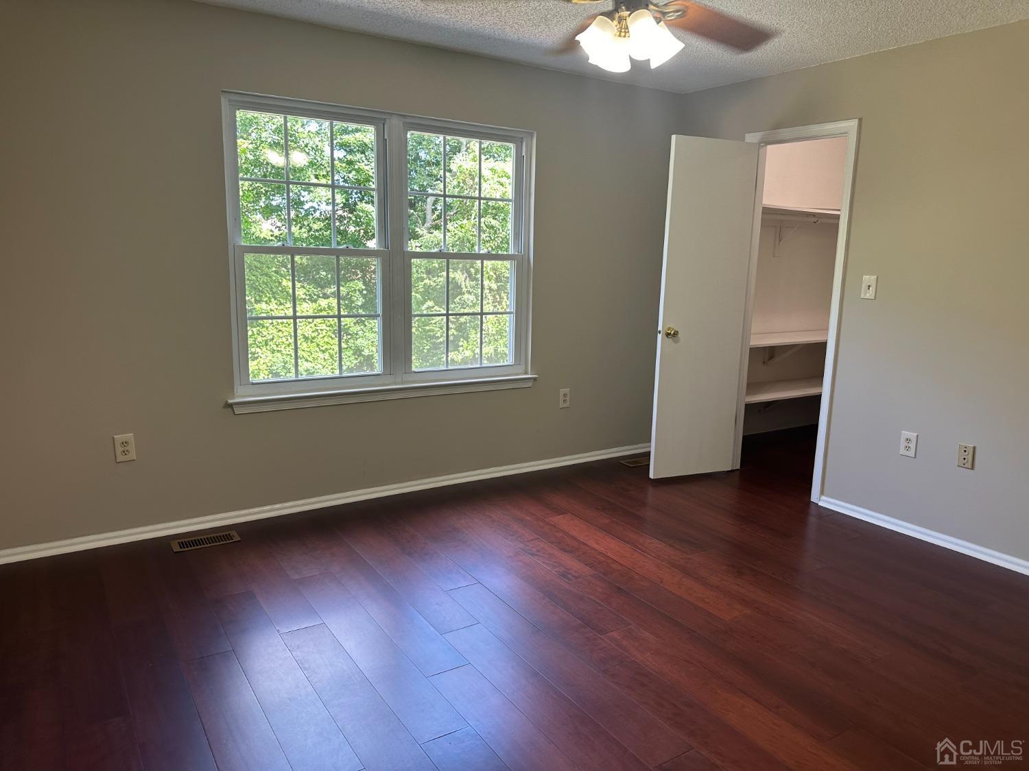 62 Goodwin Drive North Brunswick, NJ 08902 - Photo 15 of 23 a view of an empty room with wooden floor and a window