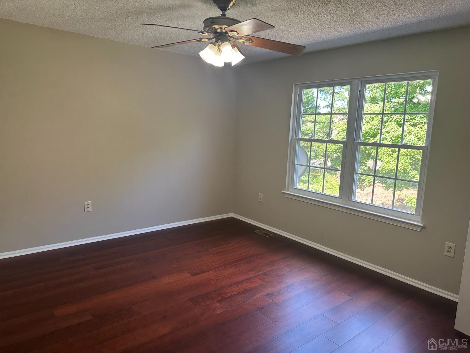 62 Goodwin Drive North Brunswick, NJ 08902 - Photo 16 of 23 wooden floor in an empty room with a window