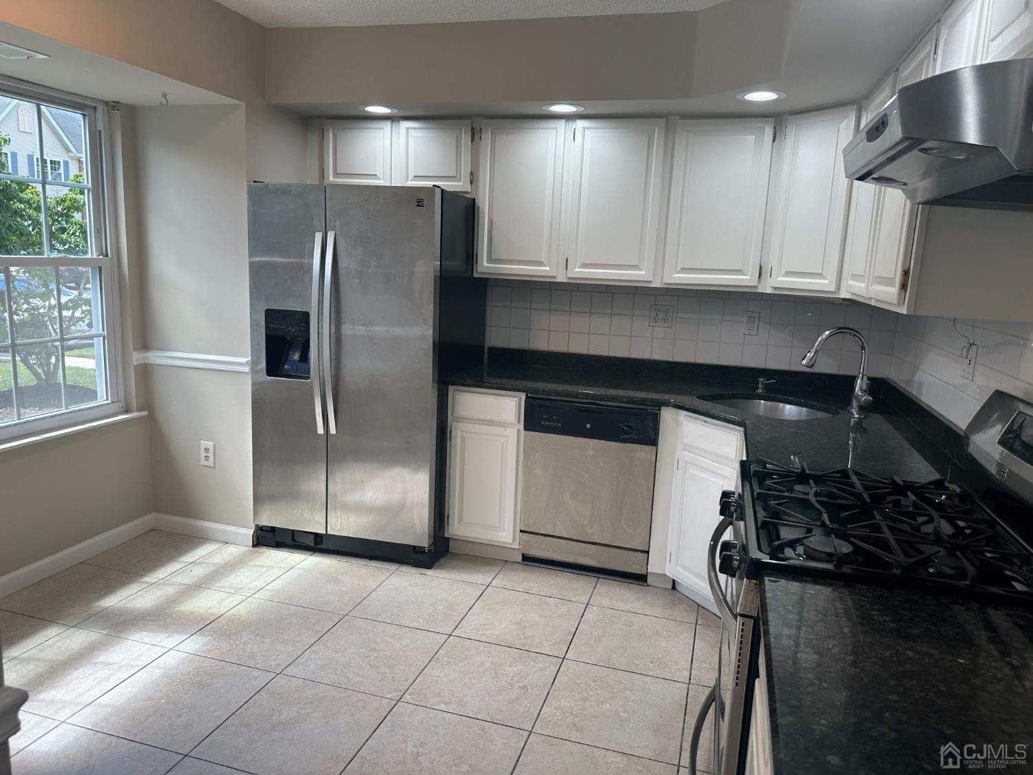 62 Goodwin Drive North Brunswick, NJ 08902 - Photo 2 of 23 a kitchen with stainless steel appliances granite countertop a refrigerator and a stove top oven