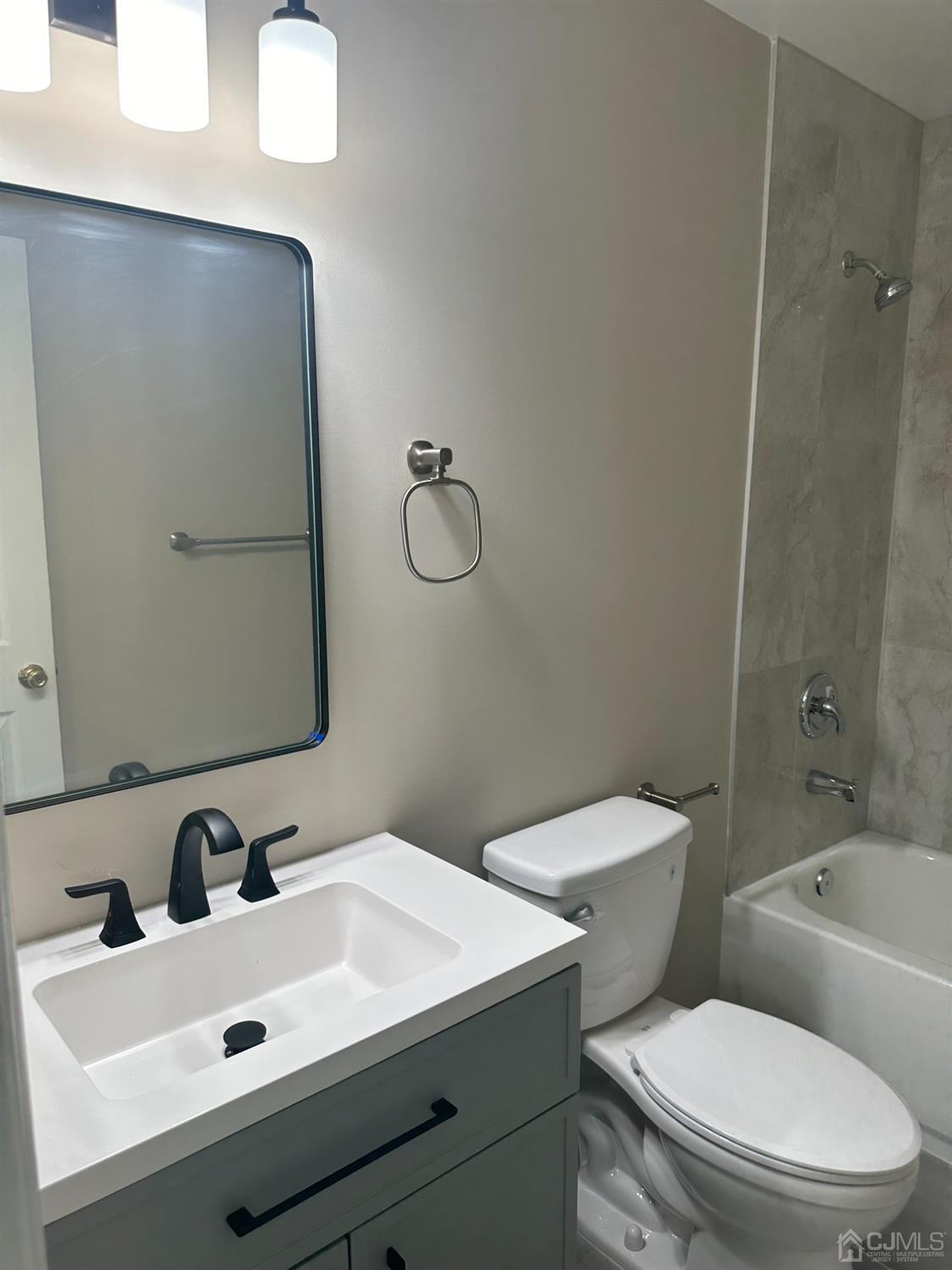 62 Goodwin Drive North Brunswick, NJ 08902 - Photo 7 of 23 a bathroom with a sink mirror vanity and toilet