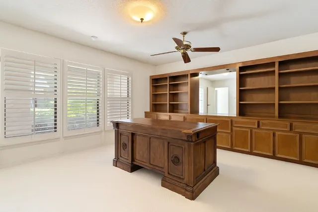 a spacious bathroom with a granite countertop double vanity and a large window