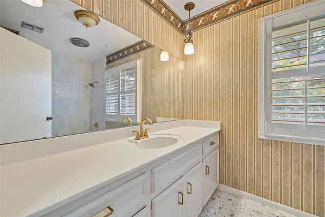 a bathroom with a sink a vanity and a mirror