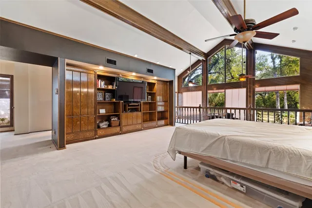 a bed room with a bed and a large window