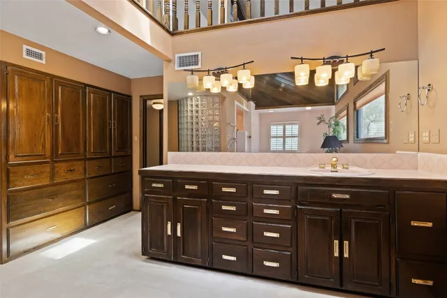a bathroom with a sink a vanity and a large mirror
