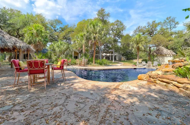 a view of a swimming pool with lounge chairs
