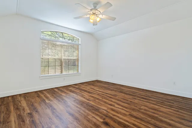 a spacious bathroom with a granite countertop sink mirror and shower