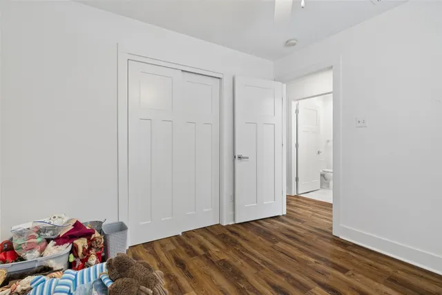 a view of a livingroom with a furniture ceiling fan and window