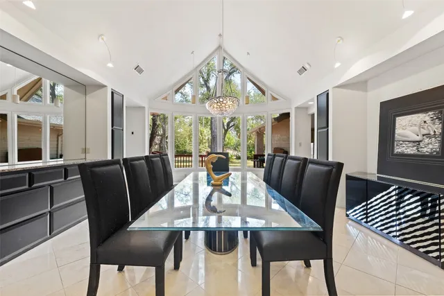a view of a dining room with furniture a chandelier and wooden floor