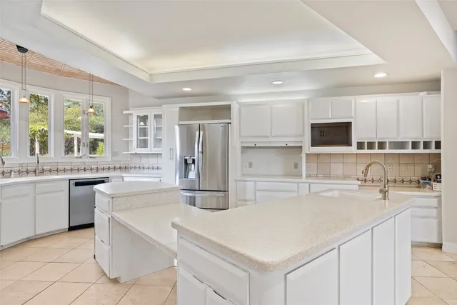 a kitchen with stainless steel appliances a sink stove and refrigerator